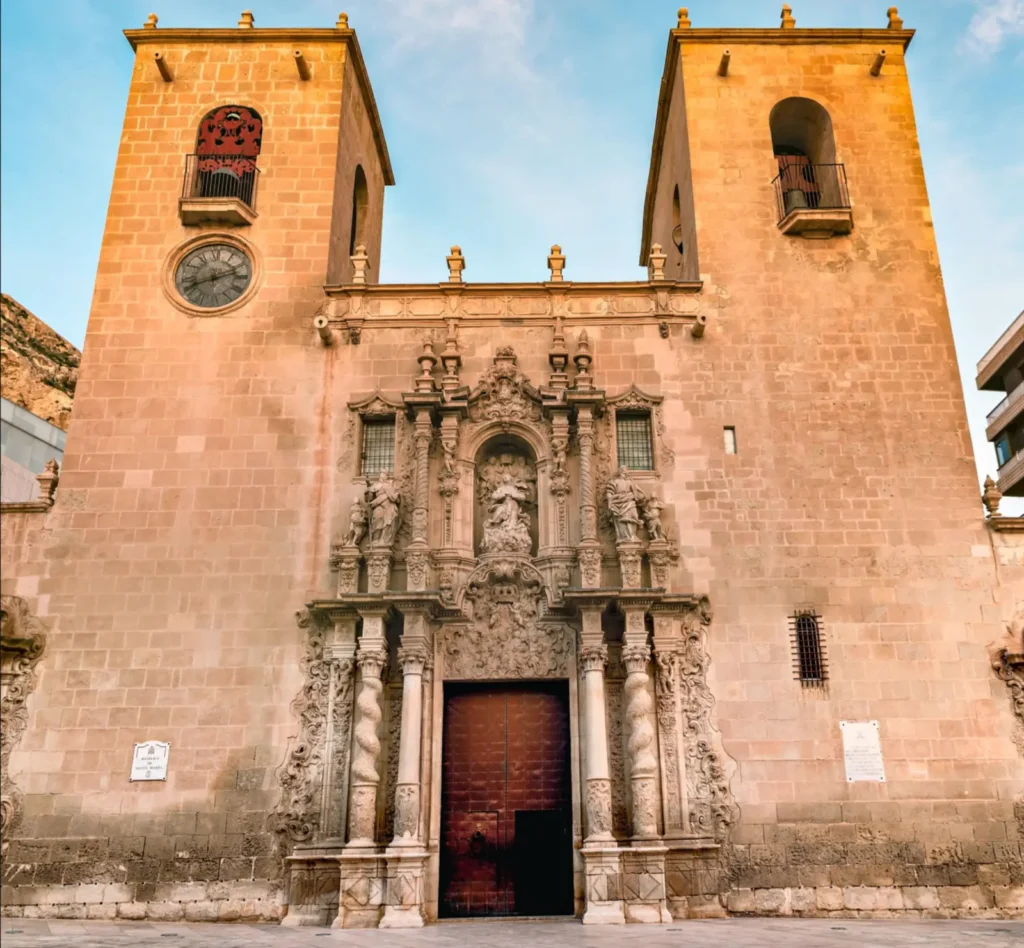 Historic Basilica of Santa María in Alicante, with its ornate Baroque façade and traditional old-town square.