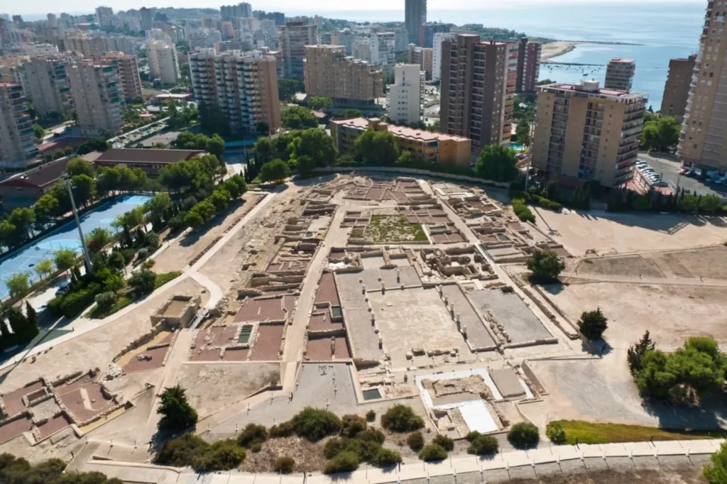 Ancient Roman archaeological ruins at Lucentum in Alicante, showing the remains of historic stone buildings and streets.