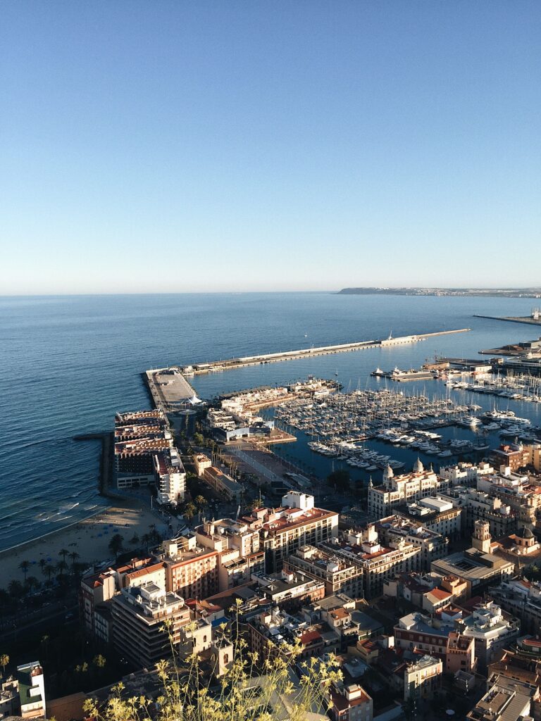Alicante in one day, panoramic views of Santa Bárbara Castle, the city, and Mediterranean harbour.