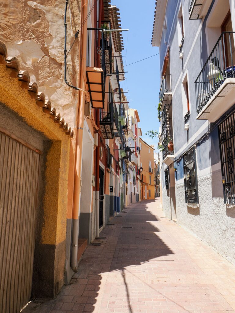 Alicante old town, colourful flower-filled streets and traditional whitewashed houses in Barrio de Santa Cruz.