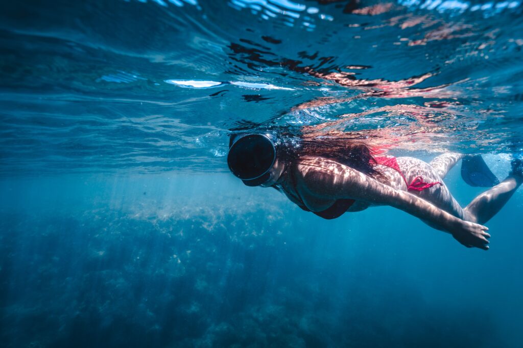 Crystal-clear Mediterranean water and rocky coves around Tabarca Island, a protected marine reserve near Alicante.