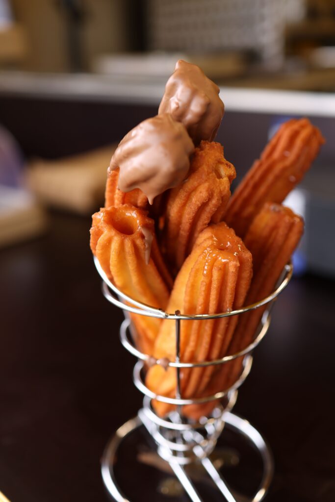 Traditional Spanish churros served with thick hot chocolate, a favourite family treat in Madrid.